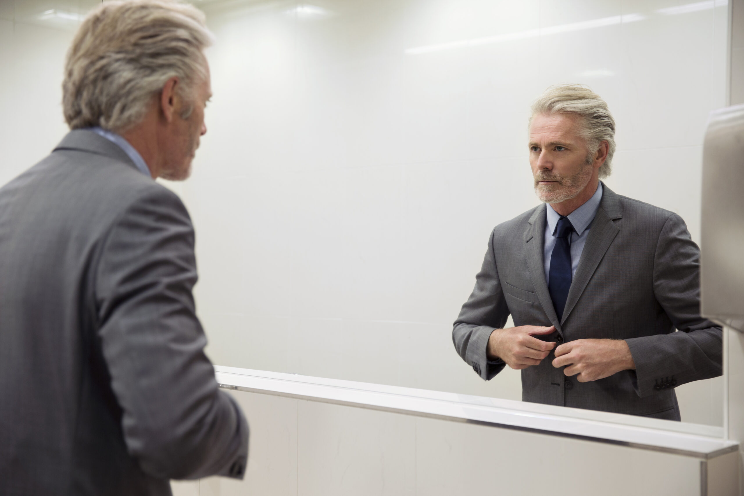 Sales professional doing articulation training in front of a mirror